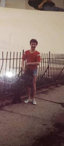 Young Ernesto Diaz standing by a fence